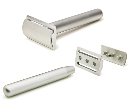 The three pieces of the Aluminum Series razor separated: handle, base plate and top cap